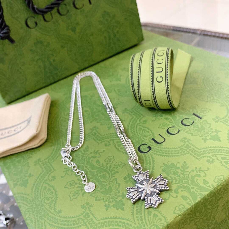 G*u*i crucifixion necklace